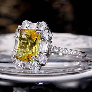 Luxurious silver ring featuring a rectangular yellow zircon center and pavé diamonds