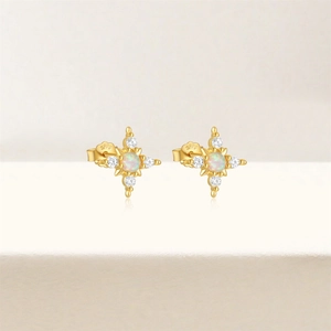 Macro shot of gold-plated S925 silver opal stud earring with star-shaped zircon setting