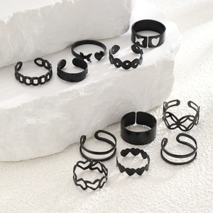Detailed close-up of an 11-piece black ring set with heart and butterfly motifs