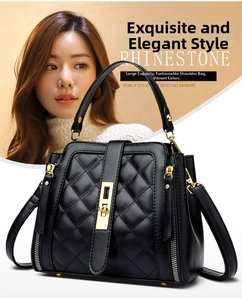 Close-up of black quilted leather bucket bag with gold lock and adjustable strap