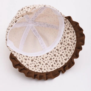 Close-up of floral baby sun hat showing interior lining and brown corduroy ruffle trim