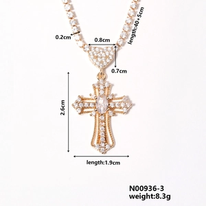 Detail view of a gold heart cross necklace with white zircon and exact dimensions