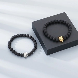 Detailed view of 8mm lava rock beads with gold and silver alloy wolf head charms