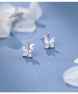 Macro detail of S999 sterling silver butterfly studs with sparkling zircon stones