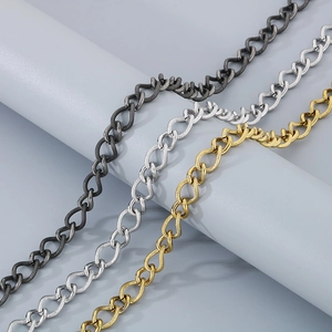 Macro view of textured stainless steel links in dark grey, silver and gold finishes