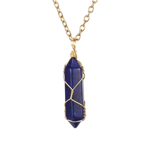 Detailed macro of a handmade wire-wrapped hexagonal Lapis Lazuli crystal pendant necklace