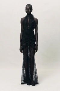 Detail of elegant black lace maxi dress featuring halter neck and ruffle accents