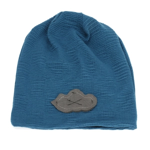 Detailed view of the wavy knit texture and cloud patch on the navy blue beanie hat