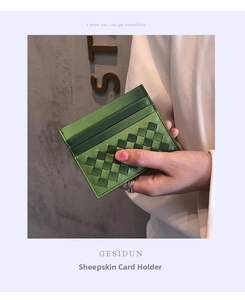 Detailed close-up of woven sheepskin card holder in grass green with precise stitching