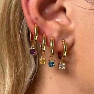 Close-up of four-color square zircon drop earrings on model in 18k gold plated finish