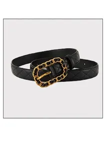 Detail of black leather belt with diamond pattern embossing and gold chain buckle