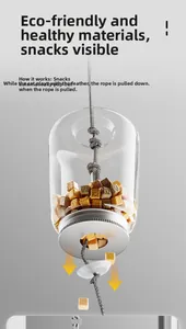 Interactive cat treat dispenser detail showing the hanging pull-rope and gravity food outlet