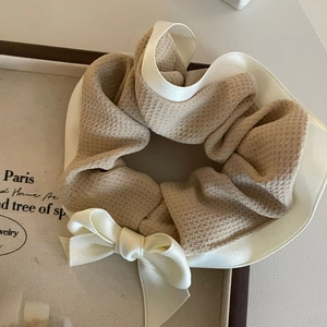 Elegant warm coffee plaid bow scrunchie with waffle knit and satin texture in a tray