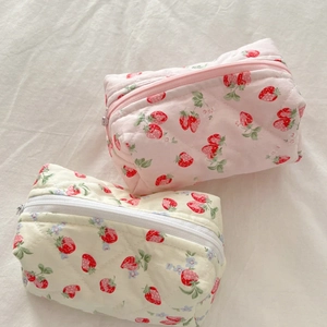 Detailed view of pink and beige quilted strawberry pattern makeup bags with zipper