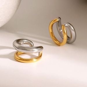 Macro detail of minimalist two-tone 18k gold and silver stainless steel ear cuffs