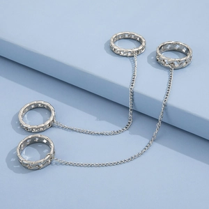 Silver punk style chain rings set with four interconnected rings on a blue background