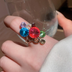Multilayer gold open ring featuring oval zircon stones in red, blue, and purple colors