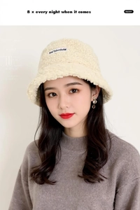 Detail of cream white faux shearling bucket hat with MiMaLaM embroidery on soft fleece