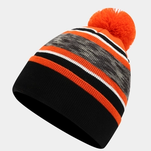 Detailed view of kids knit beanie with striped pattern and orange pom-pom for winter warmth