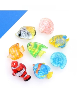 Detailed set of acrylic hair claws featuring colorful tropical fish and seashell designs