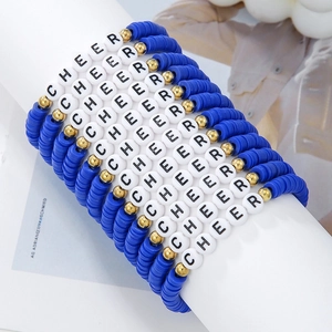 Close-up of blue Heishi bead CHEER friendship bracelets with gold spacer accents