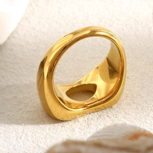 Minimalist wide gold hollow ring with teardrop cutout in polished stainless steel