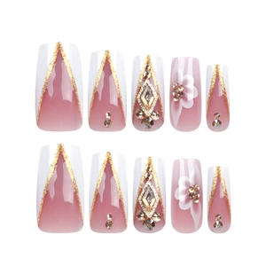 Pink and white gradient press-on nails with gold glitter, rhinestones and floral art