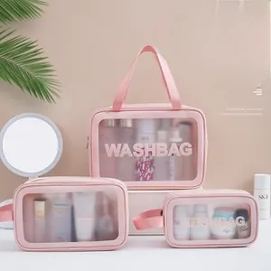 Detailed set of three pink waterproof washbags with transparent PVC and white text