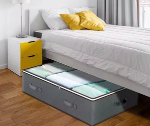 Grey underbed storage bag with clear window and handles shown sliding under a bed