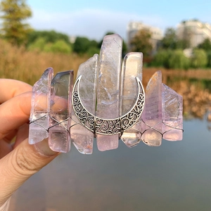 Detail of amethyst crystal hair comb with silver crescent moon and hand-woven wire