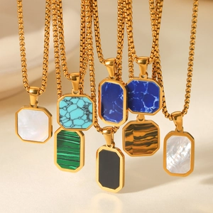 Detailed close-up of gold octagon pendants with natural stone inlays on square link chains