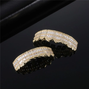 Hip-hop gold grillz set with full white zircon stones on a black reflective background