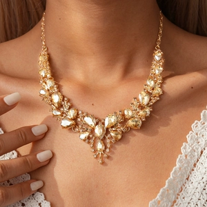 Detail view of luxury vintage teardrop necklace with champagne crystals on a model