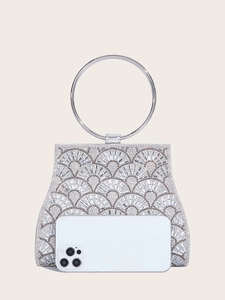 Macro view of silver evening clutch bag showing storage capacity with a smartphone inside