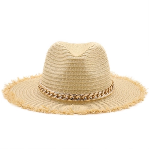 Close-up of raffia sun hat featuring a gold metal chain and trendy frayed edge detail