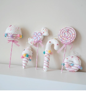 Pink and white candy ornaments including lollipops and canes with sequins for Christmas
