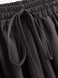 Detail of dark grey elastic waistband with matching drawstring on casual lantern pants