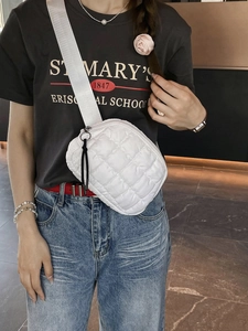 White quilted nylon crossbody waist bag with wide strap and black zipper detail