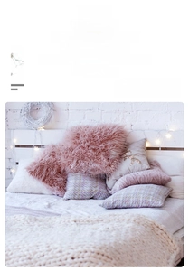 Dreamcatcher wall decor with pink plush textures and soft fairy lights in a cozy bedroom
