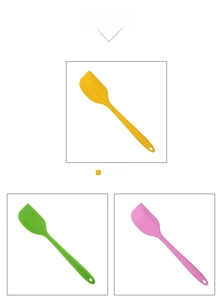 Close-up of vibrant pink, yellow, and green silicone spatulas with hanging holes