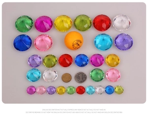 Detailed comparison of colorful acrylic ice rocks with coins for size reference