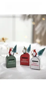 Three metal Christmas mailbox ornaments in red, green, and white with gnomes and mini trees