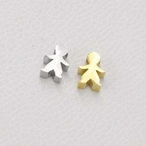 Close-up of polished gold and silver girl-shaped charms with 1.8mm holes for DIY jewelry