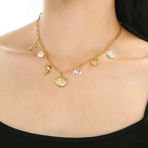 Gold plated ocean series necklace featuring starfish shell and heart charms on model