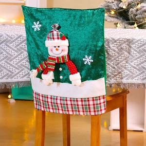 Detail of green velvet Christmas chair cover with a snowman and plaid hem on a chair