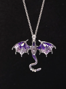 Detail of silver dragon pendant with purple enamel wings and sparkling rhinestones
