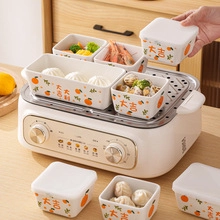 Detail of multi-functional white electric steamer with ceramic bowls for kitchen use