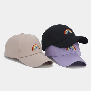 Three baseball caps in beige black and purple with colorful rainbow embroidery detail
