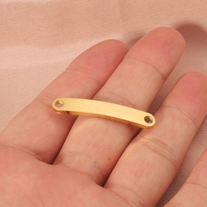 Gold stainless steel curved bar connector on hand for DIY jewelry making