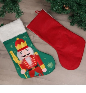 Close-up of Nutcracker and red Christmas stockings with white faux fur cuffs for decor